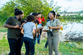 Person showing a group a bird field guide