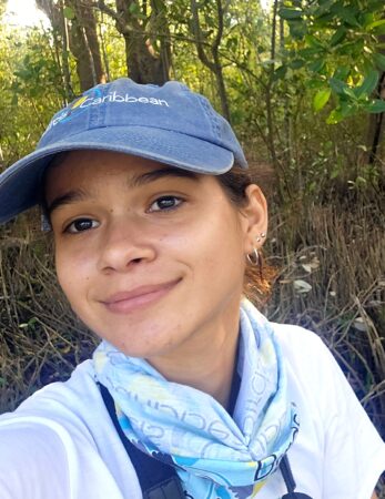 Selfie of a woman wearing a hat and a buff around her neck in a mangrove 
