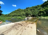Photo of a concrete road that cuts through a river.
